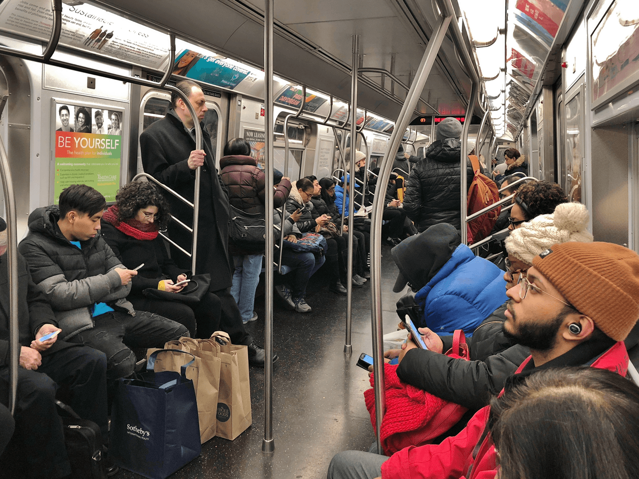 A subway car with more people.
