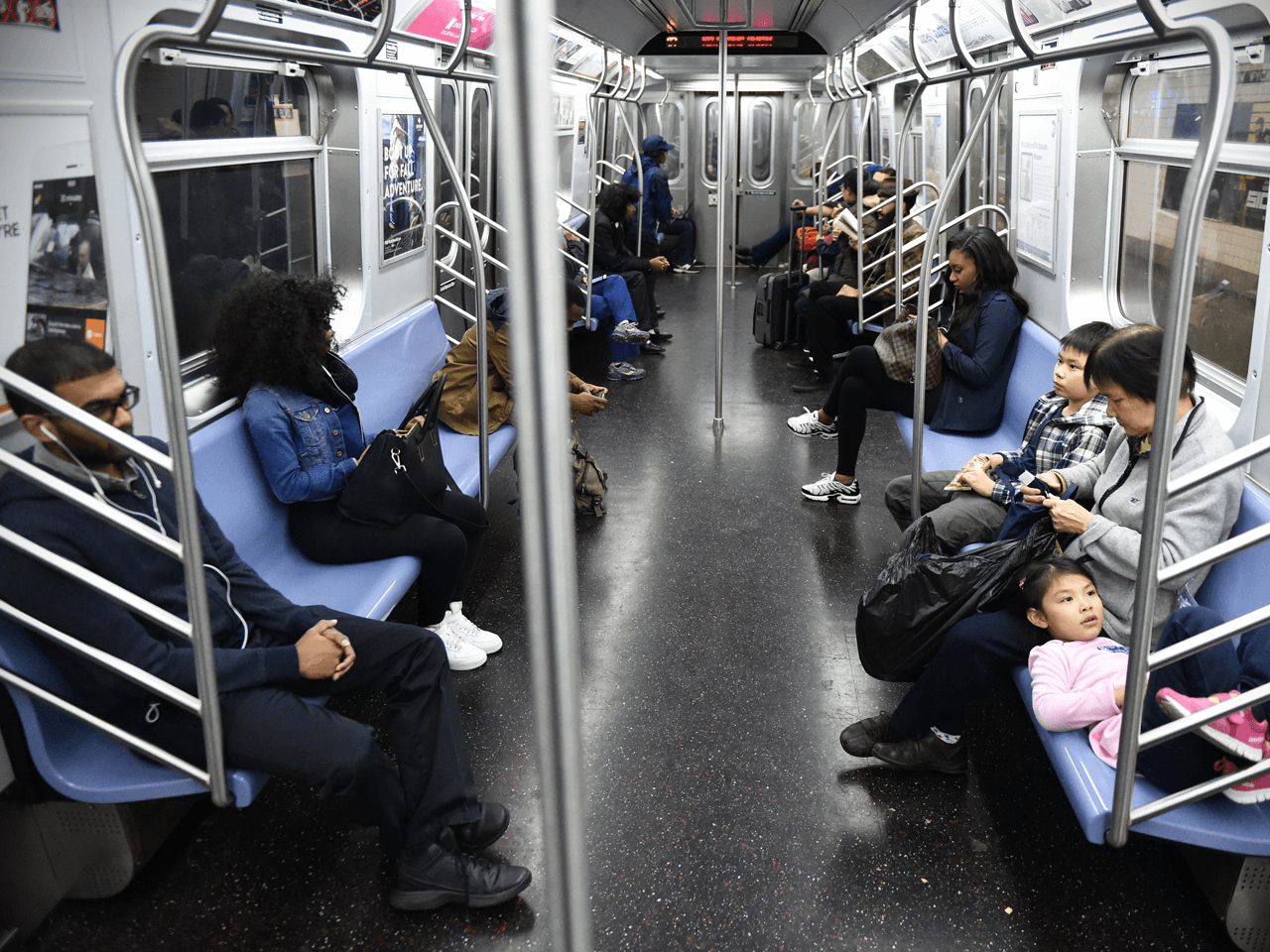 A subway car with less people.